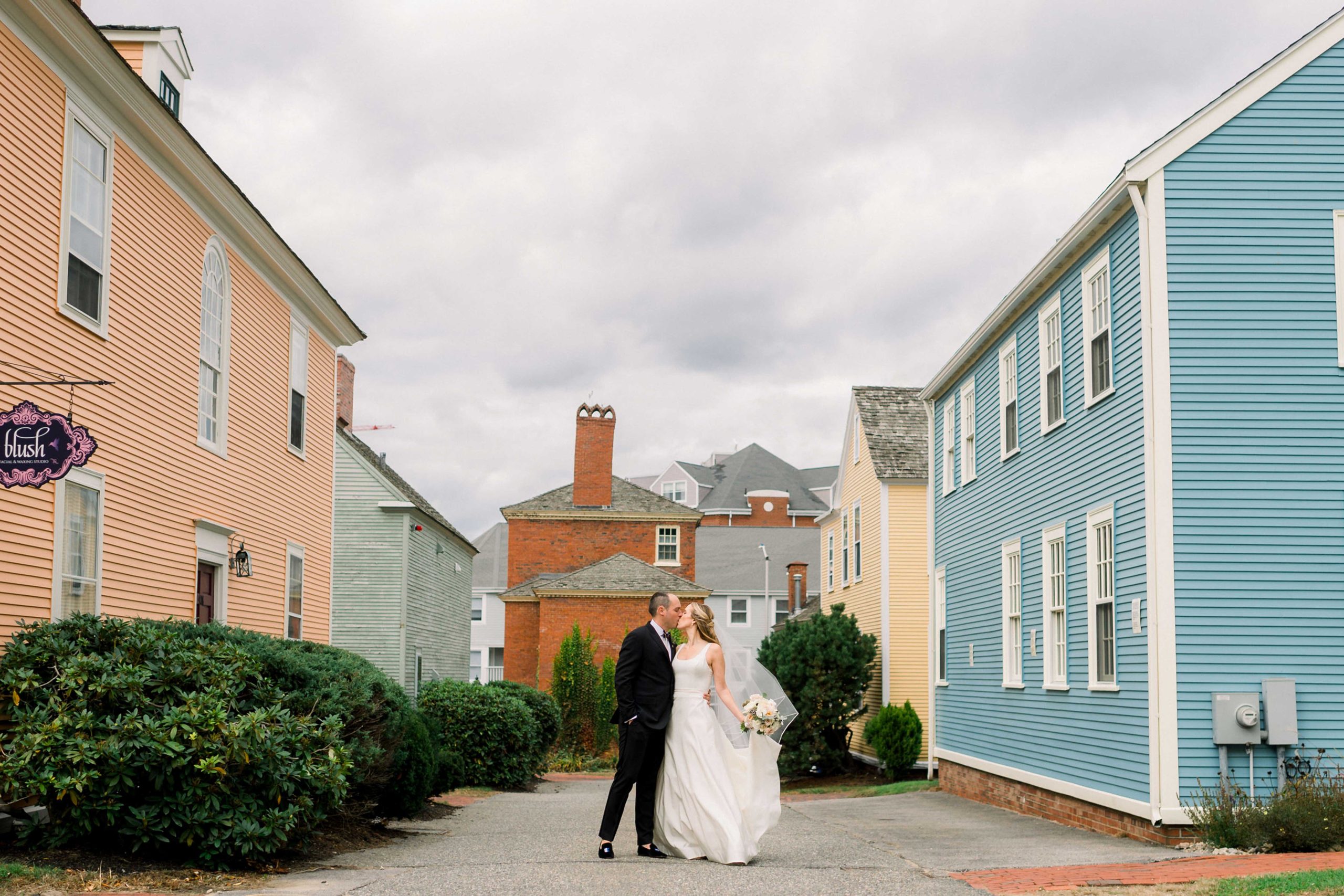 Bride and groom kissing in town of Portsmouth New Hampshire