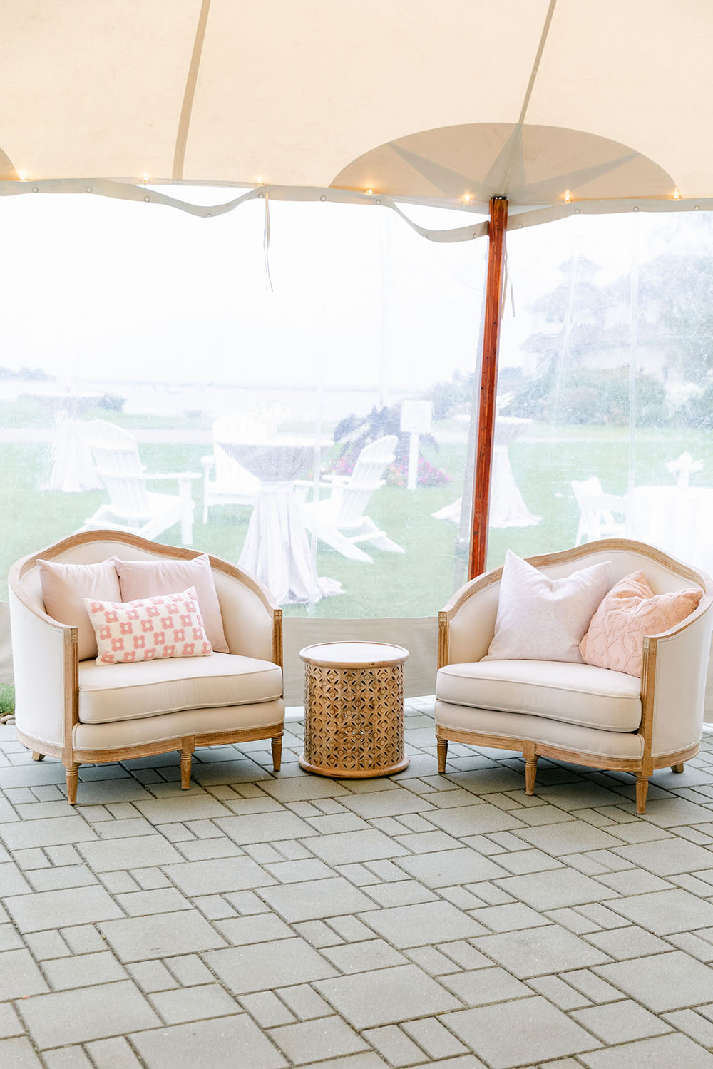 Comfy armchairs under wedding tent