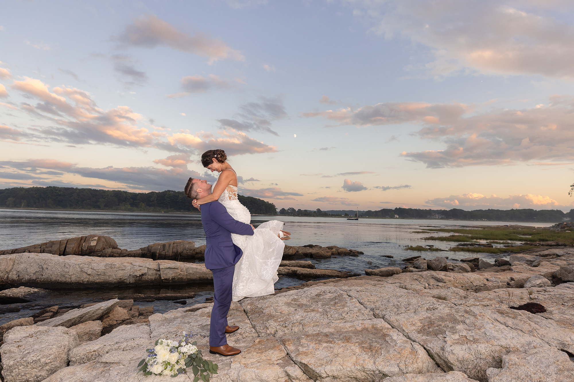 Wedding couple in front of seaside embracing