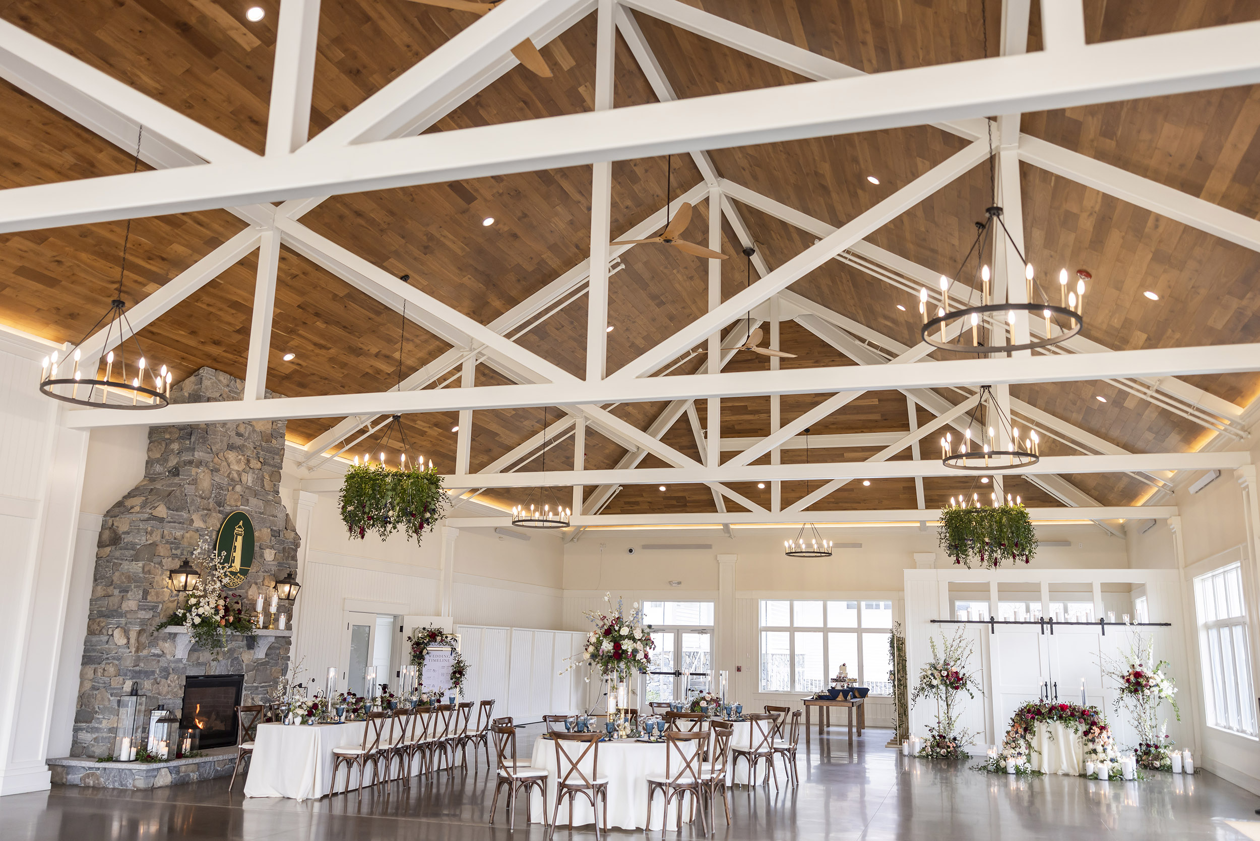 Wedding table settings inside rustic pavilion by seaside