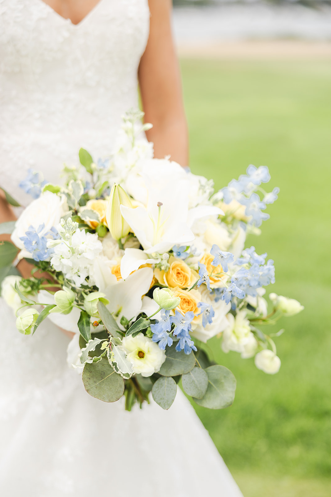 A beautiful wedding bouquet resting by a serene lake, surrounded by nature's tranquility and vibrant floral colors.