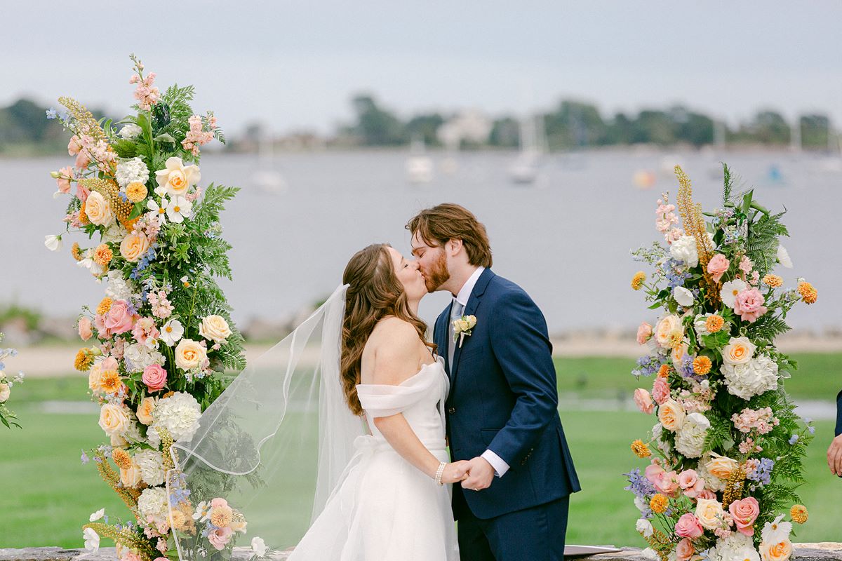  A picturesque wedding ceremony taking place at the Club at the Bay, surrounded by elegant decor and scenic views