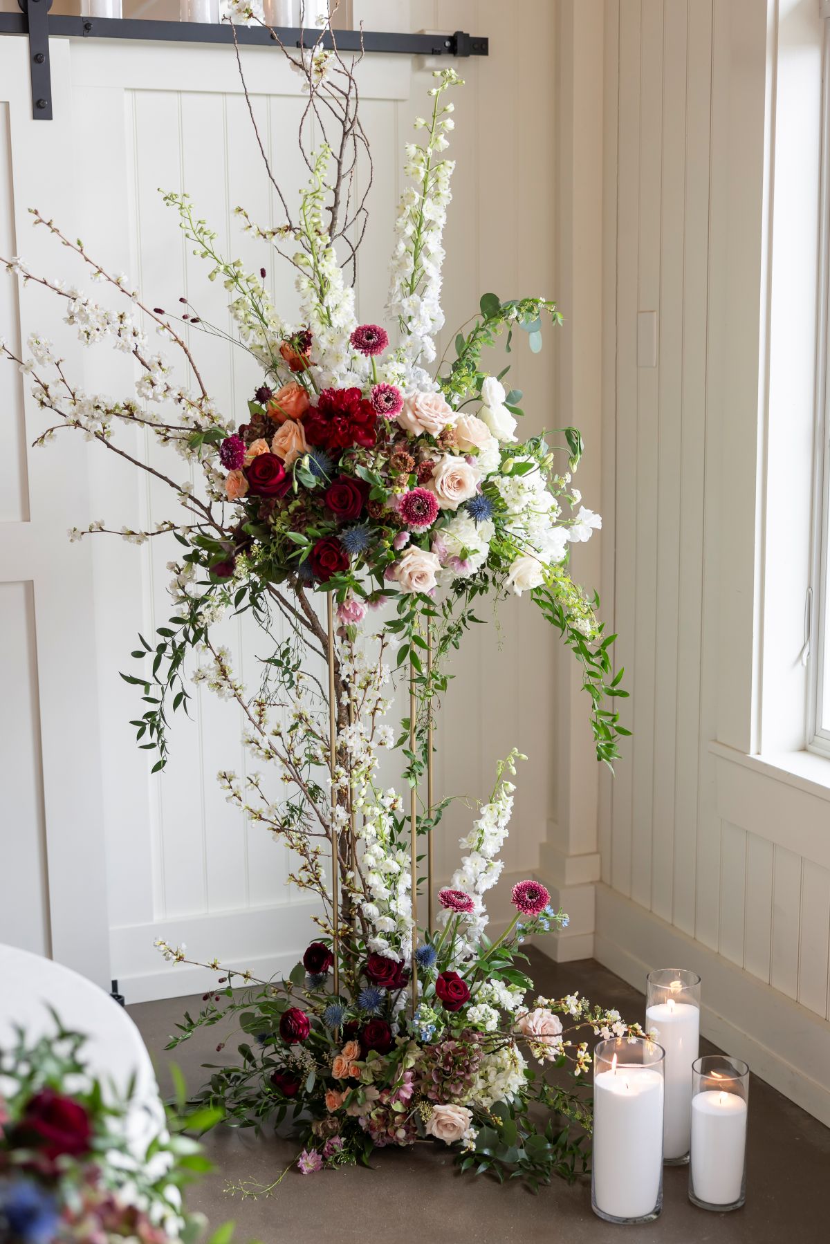 A luxurious wedding reception table adorned with elegant candles and vibrant flowers, creating a romantic ambiance.