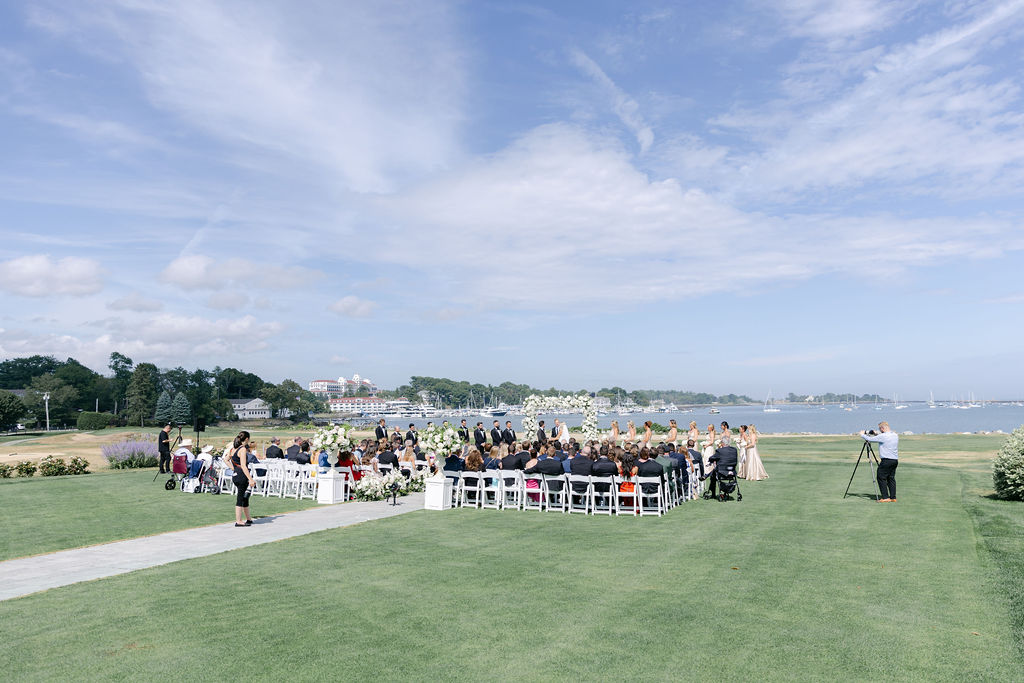 A grand dining room with a stone fireplace, beautifully arranged for a luxurious wedding reception.