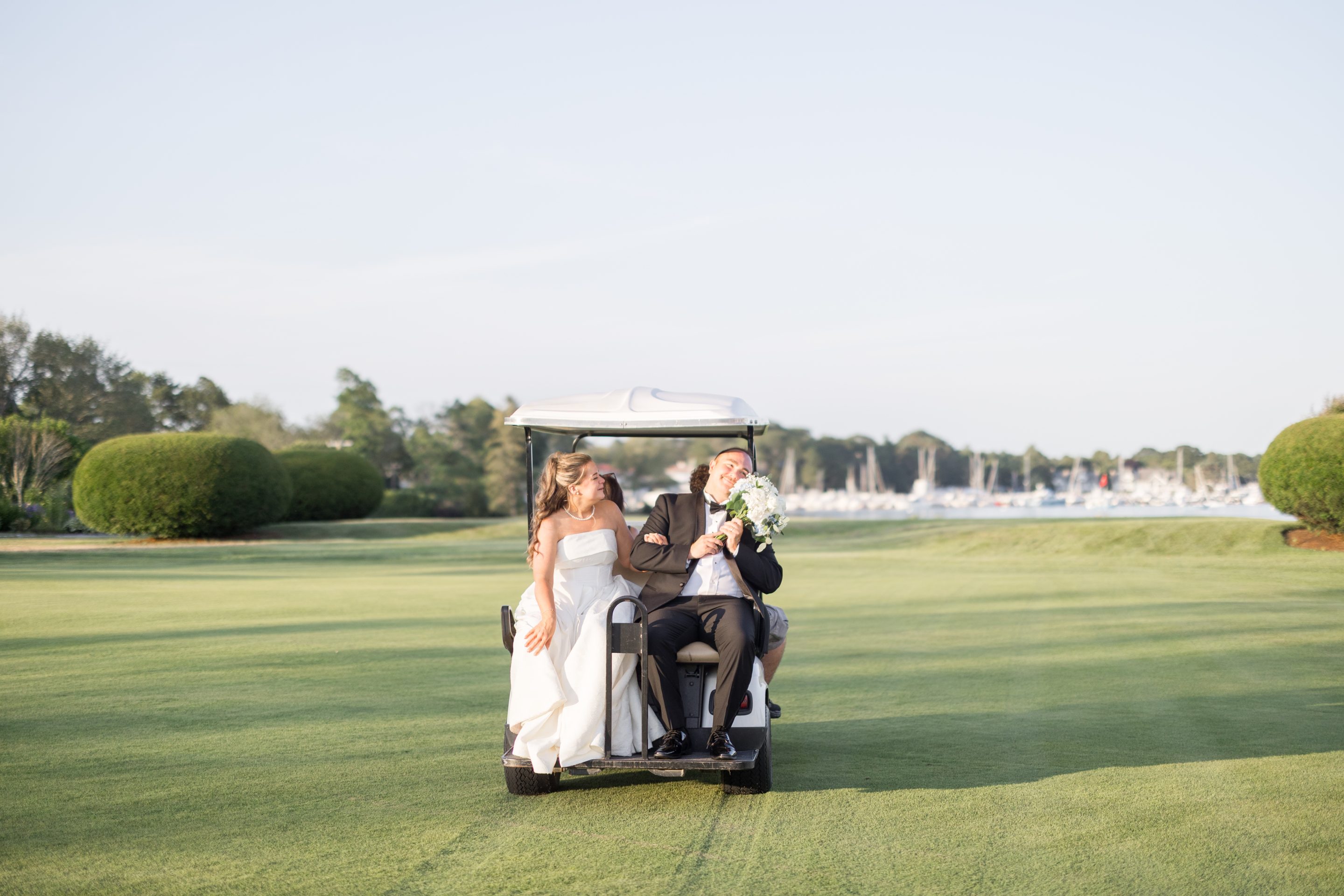 bride and groom on golf cart